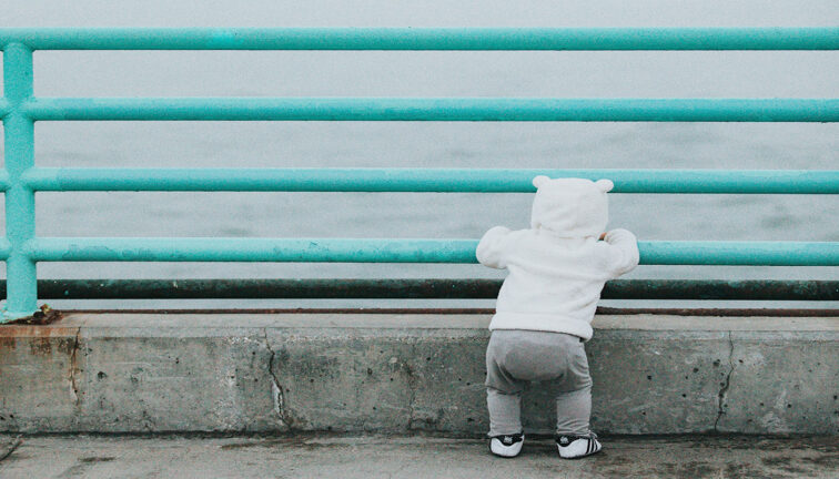 Toddler looking at the ocean