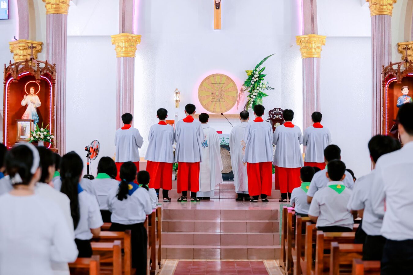 Altar Boys and Congregation Worshipping a Symbol